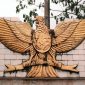 a decorative bird on the side of a building